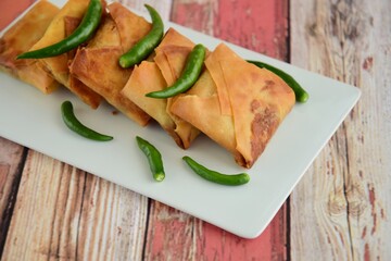 Homemade Martabak Telur, Indonesian cuisine. Pan-fried wrap filled with ground beef, egg and scallion. Served with green chilli Rawit