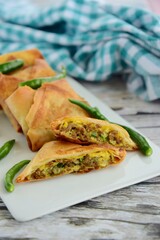 Homemade Martabak Telur, Indonesian cuisine. Pan-fried wrap filled with ground beef, egg and scallion. Served with green chilli Rawit