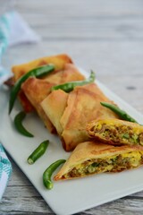 Homemade Martabak Telur, Indonesian cuisine. Pan-fried wrap filled with ground beef, egg and scallion. Served with green chilli Rawit