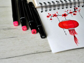 chinese lantern sketch with markers wooden background