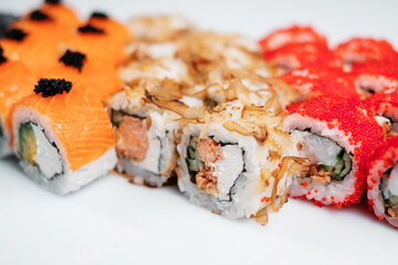 close-up view of delicious sushi set on white board.