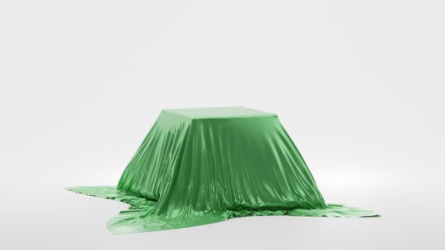 Secret present, hidden under silk fabric with drapery and folds. Surprise, award, presentation concept, podium to show magic tricks. Box, covered green wave satin cloth isolated on white background