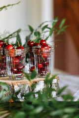 Dessert on the festive table. Glasses with berries and fruits. cherries salad. Juices and drinks