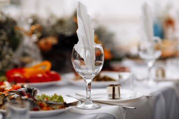 festive table setting with plates, empty glasses and napkins for weddings, birthdays, Christmas and more. restaurant interior
