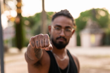 African-American with fist forward with VIDA tattoo , symbol of protest and freedom.