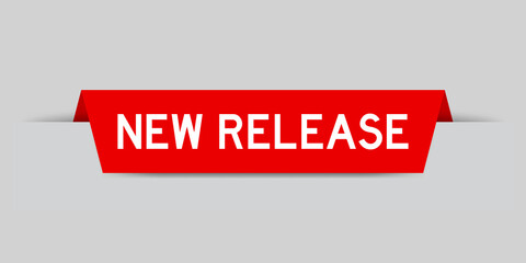 Red color inserted label with word new release on gray background