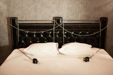 beautiful stylish bed with handcuffs for bdsm games  - obrazy, fototapety, plakaty