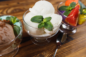 Set of ice cream scoops of different colors and flavors in glass sundae bowls. Summer delicious food, tasty refreshing dessert