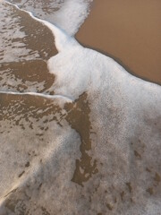 Ocean waves hit the beach in the morning, creating an impressive amount of detail and background