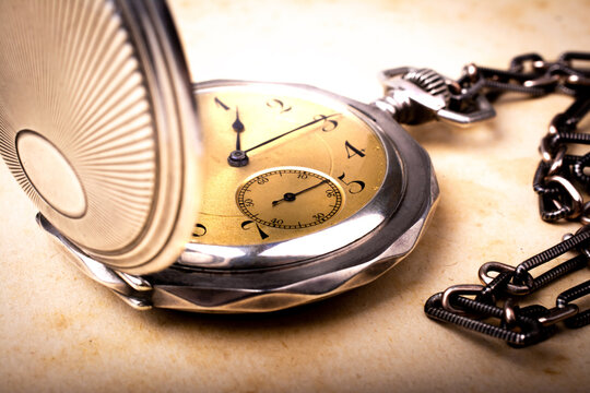 Old pocket watch with a gold dial