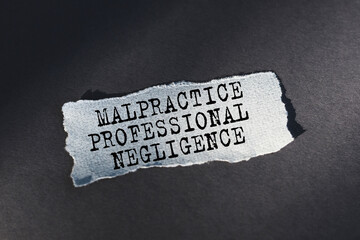 Malpractice Professional Negligence - text on torn paper on dark desk in sunlight.