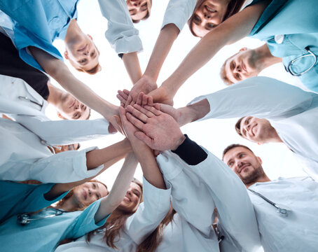 bottom view. a group of medical colleagues putting their hands together.