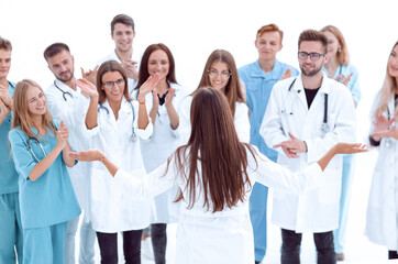 chief medical officer standing in front of his applauding colleagues
