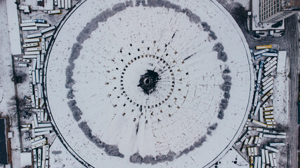 Top view aerial shot of famous Kyiv abandoned round bus park covered wtih snow, Ukraine