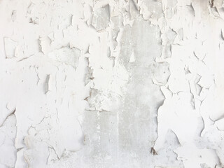 Grungy cracked white wall paint peeling off