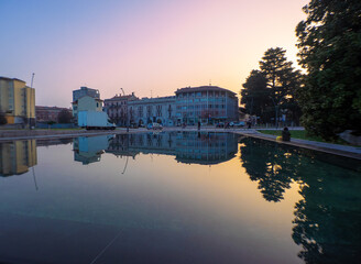 Fototapeta premium buildings reflected in a pool mirror at sunset.Legnano,metropolitan city of Milan,Italy.