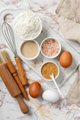 Ingredients for baking on a culinary background. Eggs, flour, dry yeast, sugar, salt on the kitchen table. The concept of preparation for yeast baking. Top view 