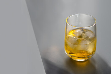 White Negroni cocktail  on grey background.  Pantone colour grey yellow.