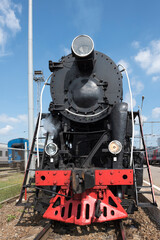 Fototapeta na wymiar The locomotive of the last century standing under steam