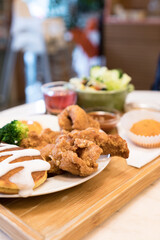 Classic USA breakfast. fried chicken, pancakes waffles, fried eggs.