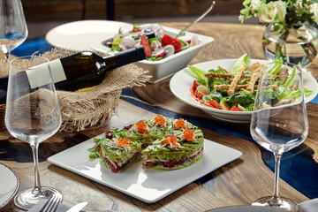 Salad of avokado, seafood, meat, vegetables and pumpkin seeds. Dietary, wholesome and tasty. Banquet festive dishes. Gourmet restaurant menu. White background.