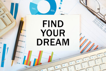 FIND YOUR DREAM is written in a document on the office desk, diagram and keyboard