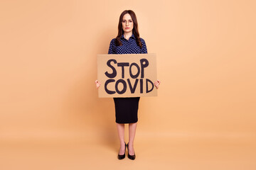 Full length body size photo of woman in formal wear keeping carton stop covid isolated on pastel...