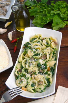 Orecchiette (little ears), a type of pasta of Apulia, with broccoli rabe and salted fish (Orecchiette con cime di rapa)