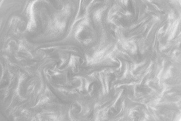 Silver paint background. Motion of the shiny liquid. Color of the year 2021 Ultimate Grey. Waves on...