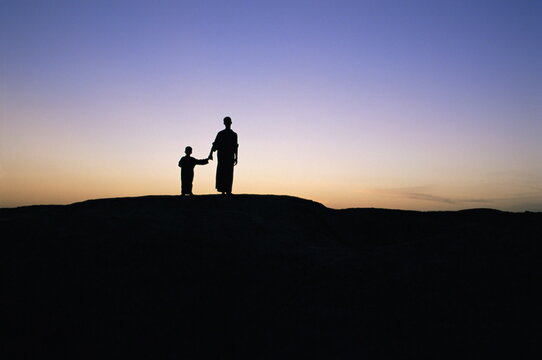 Silhouette of two people at the archaeological area, Kish, Iraq