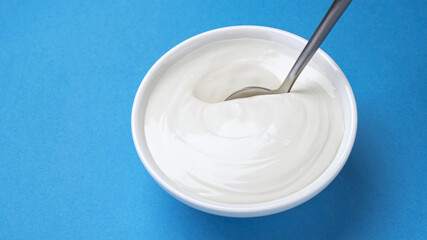 Bowl of sour cream, greek yogurt with spoon
