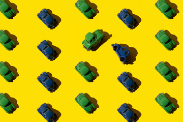 Toy retro blue and green cars in seamless pattern on yellow background. Two car had an accident and...