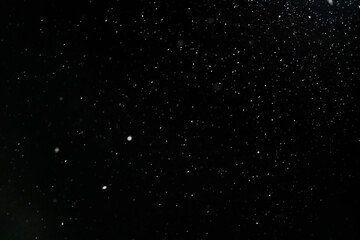 Snow on a black background. Snow background. Christmas, New Year background