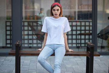 Woman wearing white blank t-shirt with space for your logo, mock up or design in casual urban style