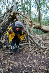 women in the woods inside a self-building refuge 