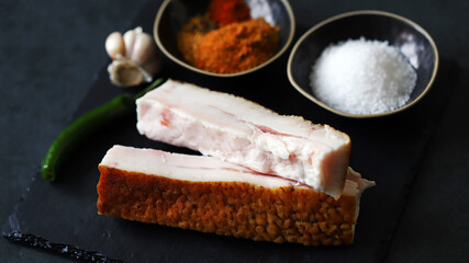 Fresh lard and spices. Salting lard.
