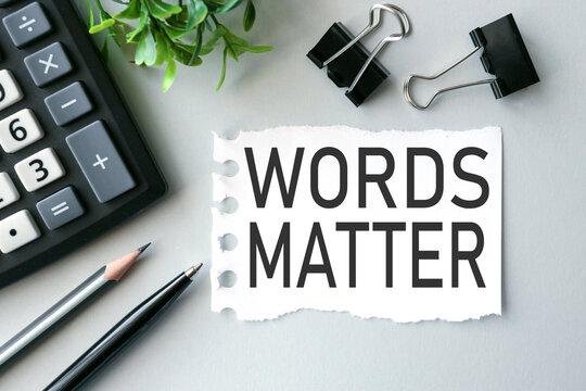 words matter. text on white paper on gray background