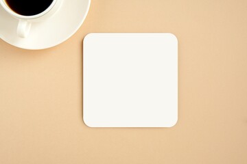 Square coaster with round corners mockup on light brown background.