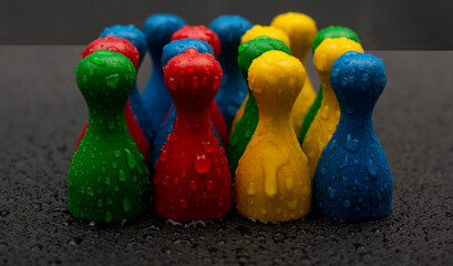 Staying strong during hard times concept shown with pawn figures facing storm