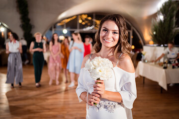 wedding tradition to throw a bouquet of bridesmaids. Fun. bride with long curls.