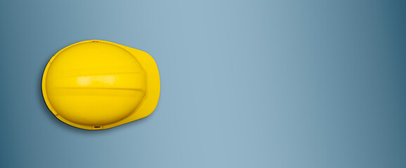 Yellow safety helmet on blue banner template with copy space