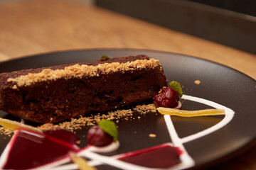 Delicious cake for desert in restaurant on a wooden table. Tasty food with coffee in cafe menu.
