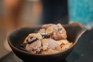 Bowl of chocolate ice cream and various topping