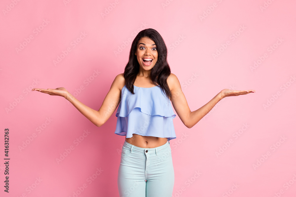 Sticker photo of impressed brunette lady hold empty space wear blue top pants isolated on pink color backgro