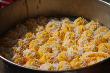 Thai cakes made from ripe palm fruit Sprinkle with grated coconut mixed with sugar, Thai dessert