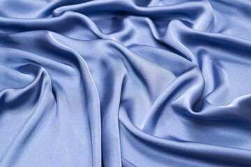 Obraz premium Blue silk or satin luxury fabric texture. Top view.