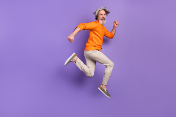 Fototapeta na wymiar Full size profile side photo of mature man happy positive smile go walk run jump hurry sale isolated over purple color background