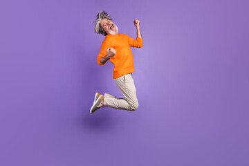 Fototapeta na wymiar Full body profile side photo of mature man excited crazy rejoice victory jump up happy smile isolated over purple color background