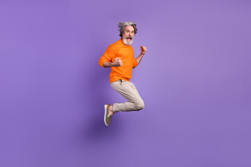 Fototapeta na wymiar Full size profile side photo of mature man excited rejoice win victory jump up happy smile isolated over purple color background