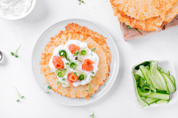 Cheese waffle with salted trout, cream cheese, cucumber and microgreen on the white table